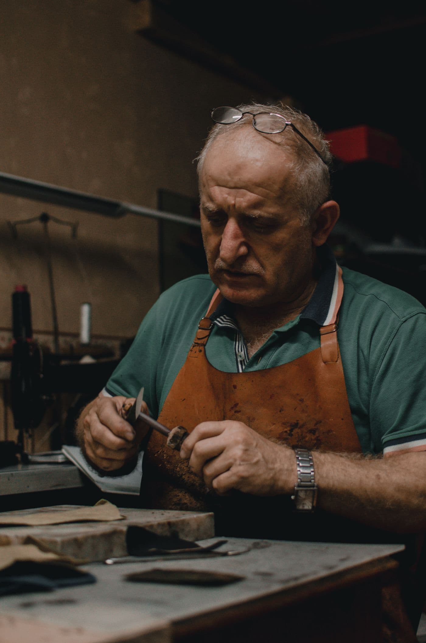 A craftsperson using hand tools at a workshop bench